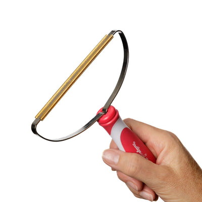 Indigo Pro Lint and Pet Hair Remover from IndigoPetco.com showing its reusable design for removing pet hair and lint from clothing and upholstery.